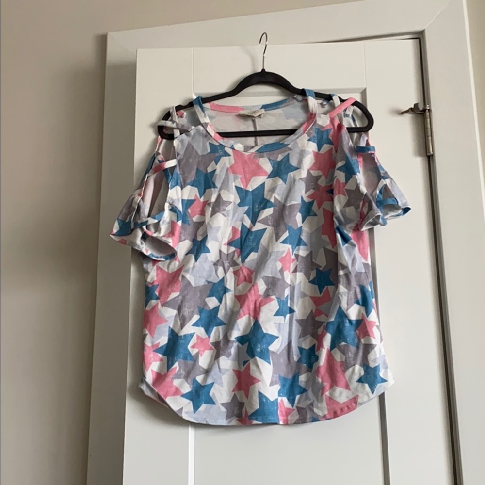 Hardly worn star shirt with cut out sleeves.